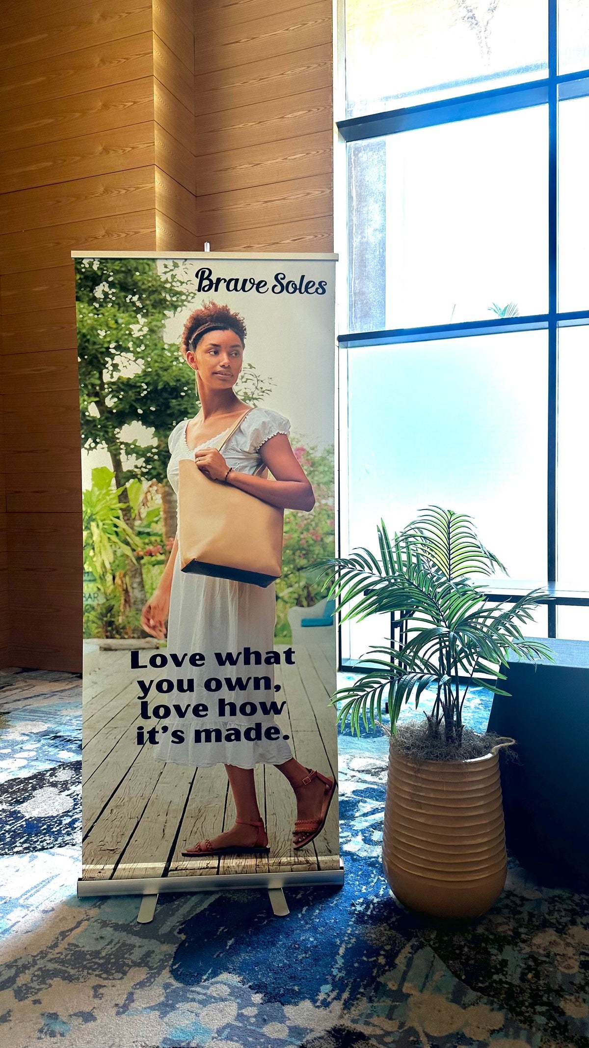 Photo from a recent corporate event featuring our sustainable gifts. The image includes a banner with the quote: 'Mindfully crafted gifts that reflect your values and vision.